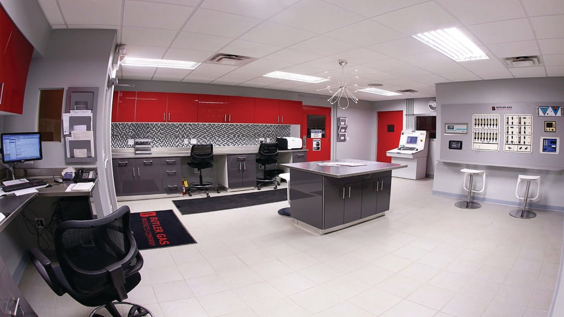 control room with various control panels, desks and chairs
