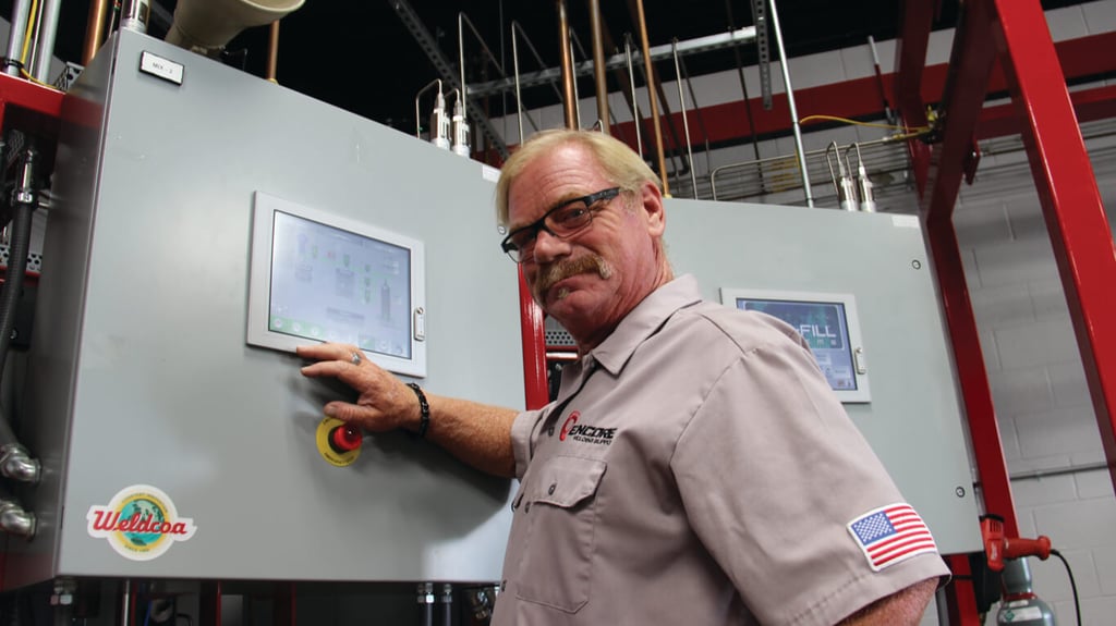Encore Welding and Industrial Supply employee at a Weldcoa branded control panel  