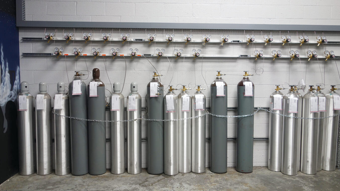 various gas cylinders getting filled with a Welcoa automated fill system