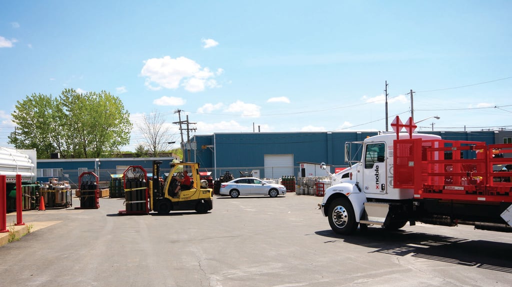 forklift moving a Weldcoa gas pallet filled with gas cylinders