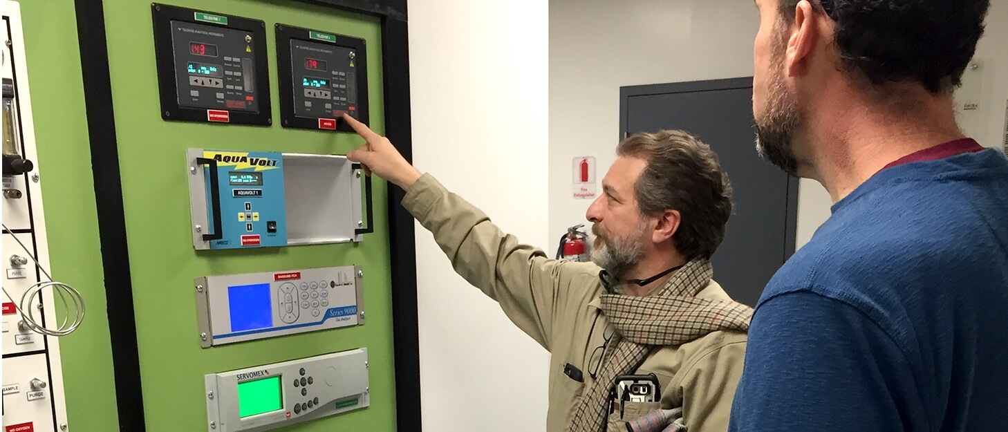 two men using a control panel