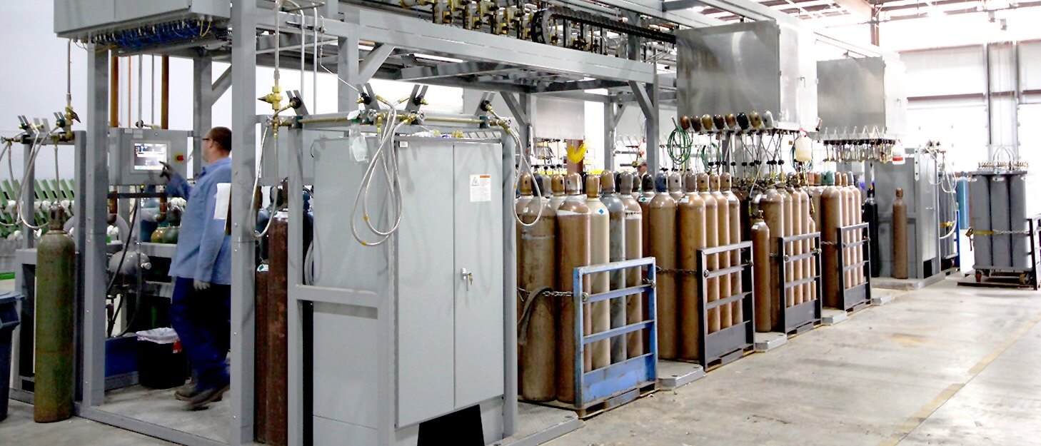 man using a control panel to fill various gas cylinders