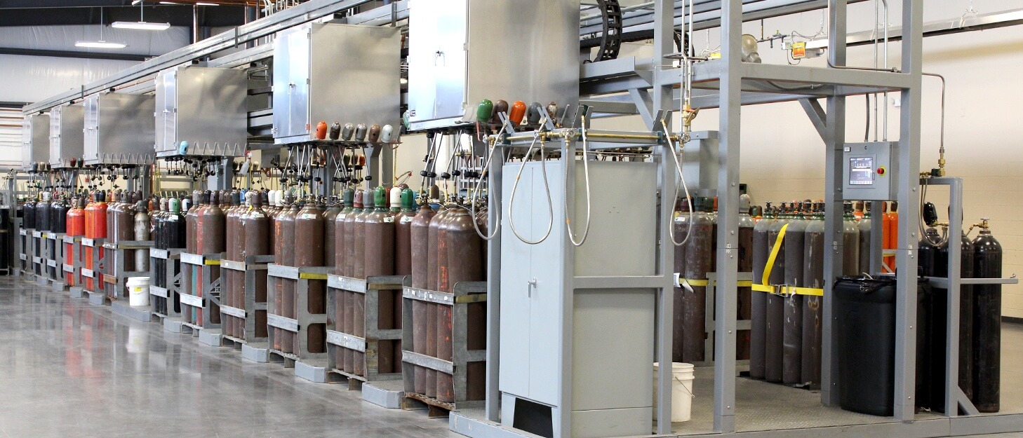 various gas cylinders getting filled by a Weldcoa automated filling station