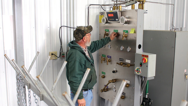 man using a control system to fill gas cylinders