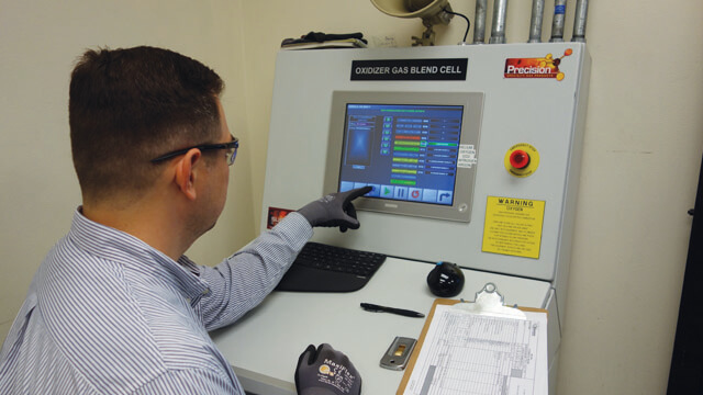 man using a control panel that fills gas cylinders
