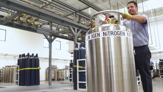 man moving a nitrogen gas cylinder